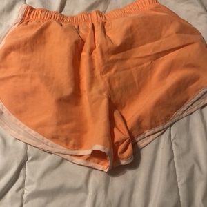 Orange Nike shorts. Size medium.